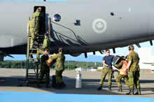 Comox, British Columbia. 1 June 2014 – Members of 407 Long Range Patrol Squadron unload a CP-140 Aurora aircraft after returning to 19 Wing Comox, B.C. from their successful participation in Operation Driftnet 2014. The Aurora crew, along with a Department of Fisheries and Oceans officer, flew several missions in support of the two-week long operation to search for and deter illegal fishing in the North Pacific Ocean. Operation Driftnet members spent nearly two weeks flying patrols over a vast area of the western North Pacific Ocean, observing more than 100 vessels. (Photo by Cpl Letourneau PJJ 19 Wing Comox. ©2014, DND-MDN CANADA)