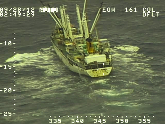 A fishing boat is seen from the onboard camera of an aircraft.
