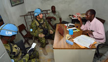 Port-au-Prince, Haiti. 16 September 2013 – Sergeant David Lapalme (right) and Corporal Marc-Daniel Benoit (left) discuss a Civil Military Cooperation project with school leaders during Operation HAMLET. (photo by: MCpl Marc-Andre Gaudreault, Canadian Forces Combat Camera)