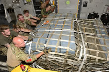 Albania. 7 September 2014 - Canadian Armed Forces members, United States Air Force members and Danish Forces members, load equipment onto a CC-177 Globemaster aircraft in Albania during Operation IMPACT on September 7, 2014. (Photo: MCpl Patrick Blanchard, Canadian Forces Combat Camera)