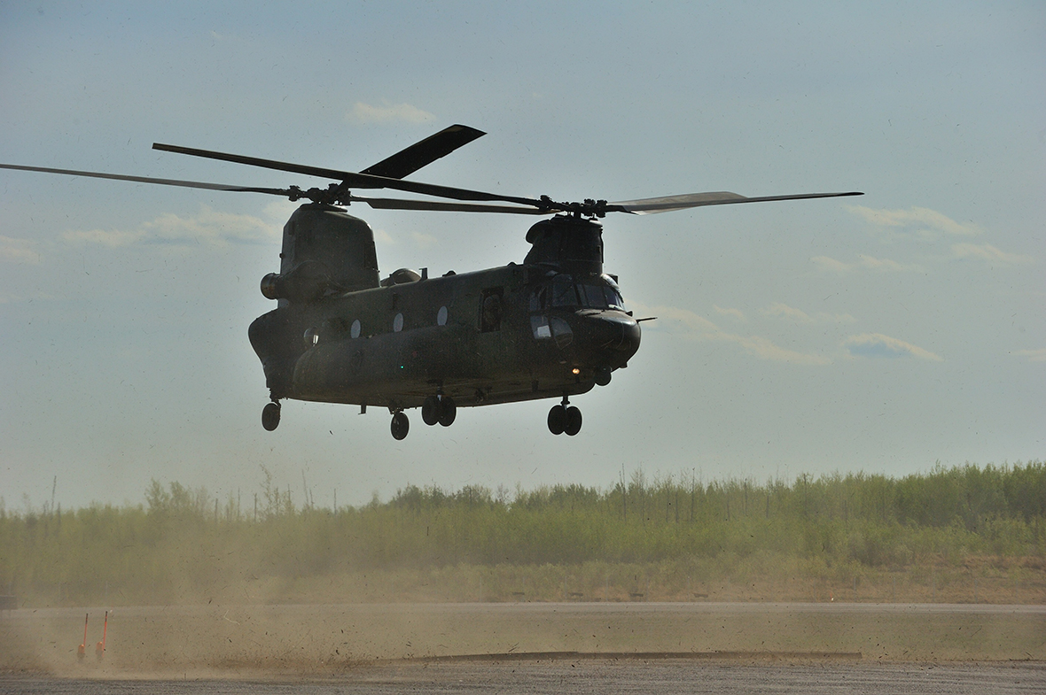 A CH-147F Chinook helicopter lands at Leismer Aerodrome in Conklin, Alberta, on May 6, 2016, as part of Canadian Armed Forces support to the Province of Alberta's emergency response to wildfires in Fort McMurray. This is the first time a CH-147F Chinook has been used in a domestic humanitarian operation. Photo: Master Corporal VanPutten, 3 CSDB Imaging