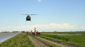 Portage la Prairie, Manitoba. 7 July 2014 - A CH-146 Griffon helicopter investigates the flood damage by the Portage Diversion near Portage la Prairie, Manitoba during Operation LENTUS 14-05. (Photo: Corporal Darcy Lefebvre, Canadian Forces Combat Camera)