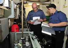 Toulon, France, 11 April 2012 – Able Seaman Brent Hillier (left) and Leading Seaman Mitchell Earle prepare to do routine maintenance on an air compressor onboard Her Majesty's Canadian Ship Charlottetown while on a port visit to Toulon, France with Standing NATO maritime Group 1. (Photo by Cpl Ronnie Kinnie, Formation Imaging Services, Halifax)