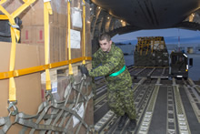 8 Wing Trenton. 28 April 2015 – A Canadian Armed Forces member loads a CC-177 Globemaster with aid for the treatment and recovery of people after the earthquake in Nepal, from Canadian Forces Base Trenton on April 28, 2015. (Photo:  Corporal Dan Strohan, 8 Wing Imaging)