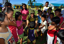 Corporal Joel Majaralie from 2 Combat Engineer Regiment, Petawawa plays with the local children during Operation RENAISSANCE, in Pontevedra, Philippines on November 24, 2013. Photo: MCpl Marc-Andre Gaudreault, Canadian Forces Combat Camera IS2013-2006-096