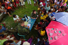 A medical group from the Canadian Armed Forces Disaster Assistance Response Team proceeds with patient triage during Operation RENAISSANCE, in Sara, Philippines on November 26, 2013. Photo: MCpl Marc-Andre Gaudreault, Canadian Forces Combat Camera IS2013-2006-106