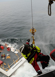 Prince Rupert, British Columbia. 30 April 2013 – Search and Rescue Technician, Sergeant Robert Hardie is hoisted into a Royal Canadian Air Force Cormorant helicopter as it hovers over the deck of United States Coast Guard CUTTER CHANDELEUR, during a search and rescue exercise held on April 30, 2013 off the coast of Prince Rupert, B.C. (Photo: Cpl Jennifer Chiasson, 19 Wing Comox)