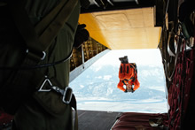 Hope, British Columbia. 26 February 2014 - Sergeant Rob Hardie, Search and Rescue Technician, leaps off the back ramp of a 442 Transport and Rescue Squadron Buffalo aircraft during a response to a simulated plane crash. (Photo: Bdr Albert Law, 39 Canadian Brigade Group)