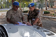 Famagusta, Cyprus. 24 November 2008 – Captain Michael Solonynko (left), Operation and Information Analyst Officer for the UN HQ in Cyprus, reviews a map at Camp General Stefanik in Famagusta, Cyprus with his counterpart Sector 4 Ops Info Officer Captain Slovomir Smidl from Slovakia, prior to conducting a patrol in the Buffer Zone boundary between sectors 2 and 4. (Photo by MCpl Robert Bottrill, Canadian Forces Combat Camera)