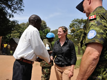 Yambio, South Sudan. 4 December 2012 – Catherine Fleming, Head of the stabilization office of the Embassy of Canada for South Sudan, and Commander Paul Earnshaw, Canadian military liaison officer in the United Nations Mission in the Republic of South Sudan (UNMISS) greet Mister Paulino Mangbondo, payam administrator, from the village of Sakure, near the Congo border during Operation SOPRANO. (Photo : Sgt Norm McLean, Canadian Forces Combat Camera)