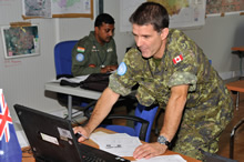 Juba, South Sudan, 5 December 2012 – Major Francois Lavigne, Joint-Operation Center (JOC) Senior Staff Officer for United Nations Mission in the Republic of South Sudan (UNMISS) reads important publications at his office. (photo by: Sgt Norm McLean, Canadian Forces Combat Camera)