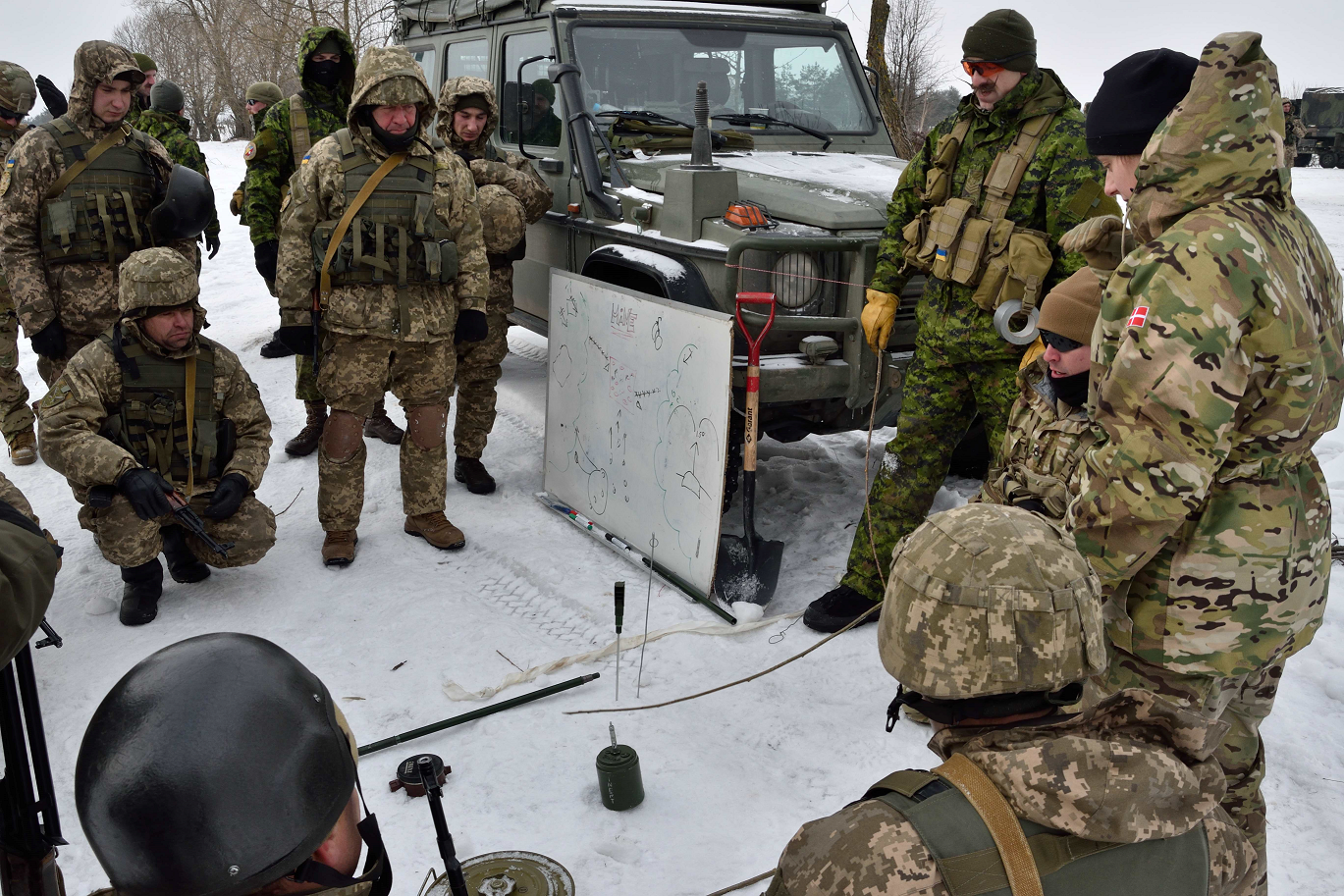A Danish linguist with Joint Task Force - Ukraine translates for Canadian and American Counter - Improvised Explosive Device instructors teaching Ukrainian soldiers at the International Peacekeeping and Security Centre in Starychi, Ukraine on February 7, 2017. (Photo: Joint Task Force – Ukraine)