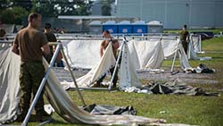 Soldiers from Joint Task Force (East) build a temporary camp to accommodate asylum seekers near the Saint-Bernard-de-Lacolle border crossing in Quebec during Operation ELEMENT, August 9, 2017. Photo: Corporal Myki Poirier-Joyal, St-Jean/Montreal Imagery Section