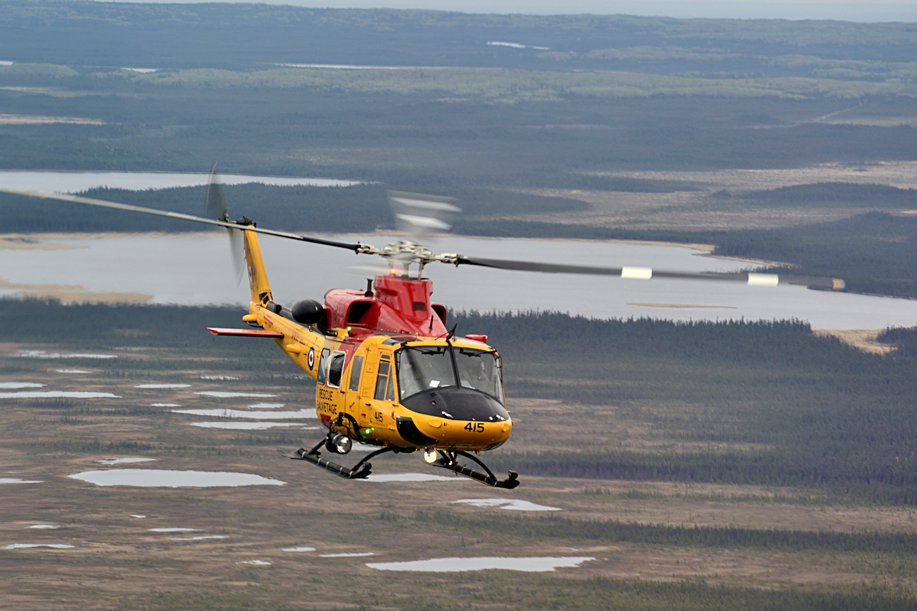 A CH-146 Griffon helicopter from 417 Search and Rescue Squadron based in Cold Lake, Alberta conducts operations over northern Alberta while providing assistance to the province during wildfires near Fort McMurray on May 9, 2016. Photo: MCpl Brandon O'Connell, 3 CDN DIV PA