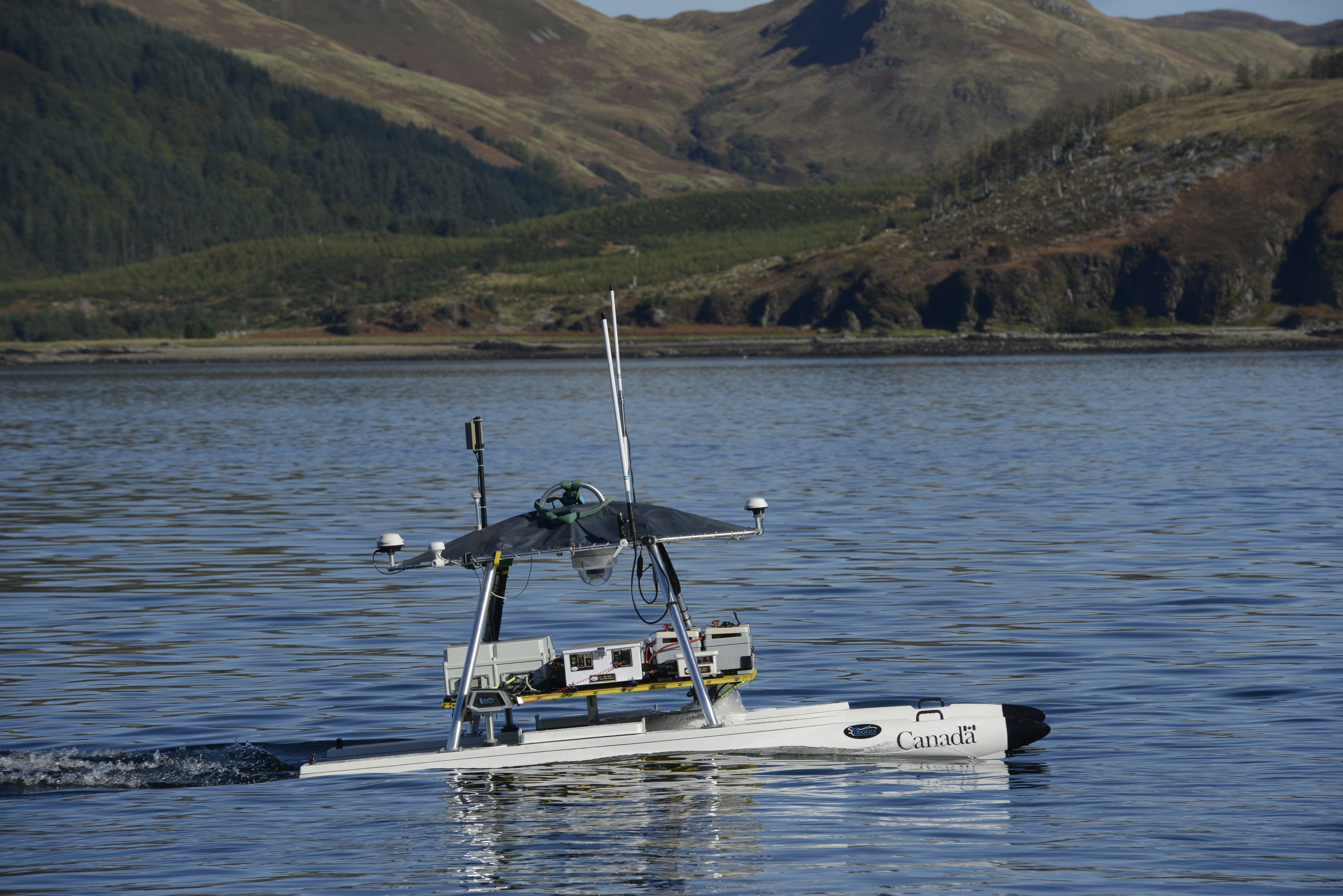 Defence Research and Development Canada’s unmanned surface vehicle USV-2600 performs an autonomous mission in the water at Loch Alsh. Photo by Janice Lang, DRDC