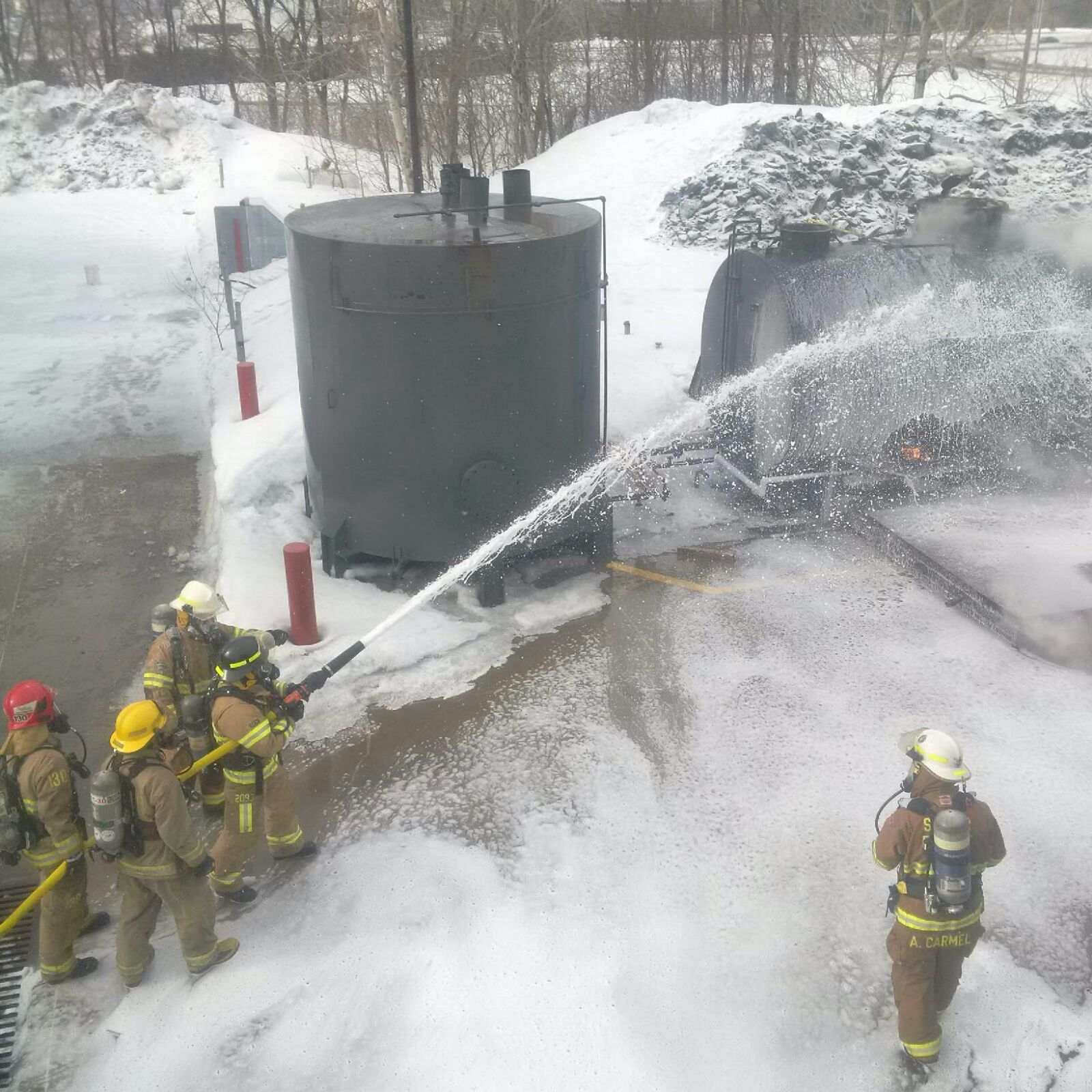Firefighters use foam to extinguish crude oil fire. 