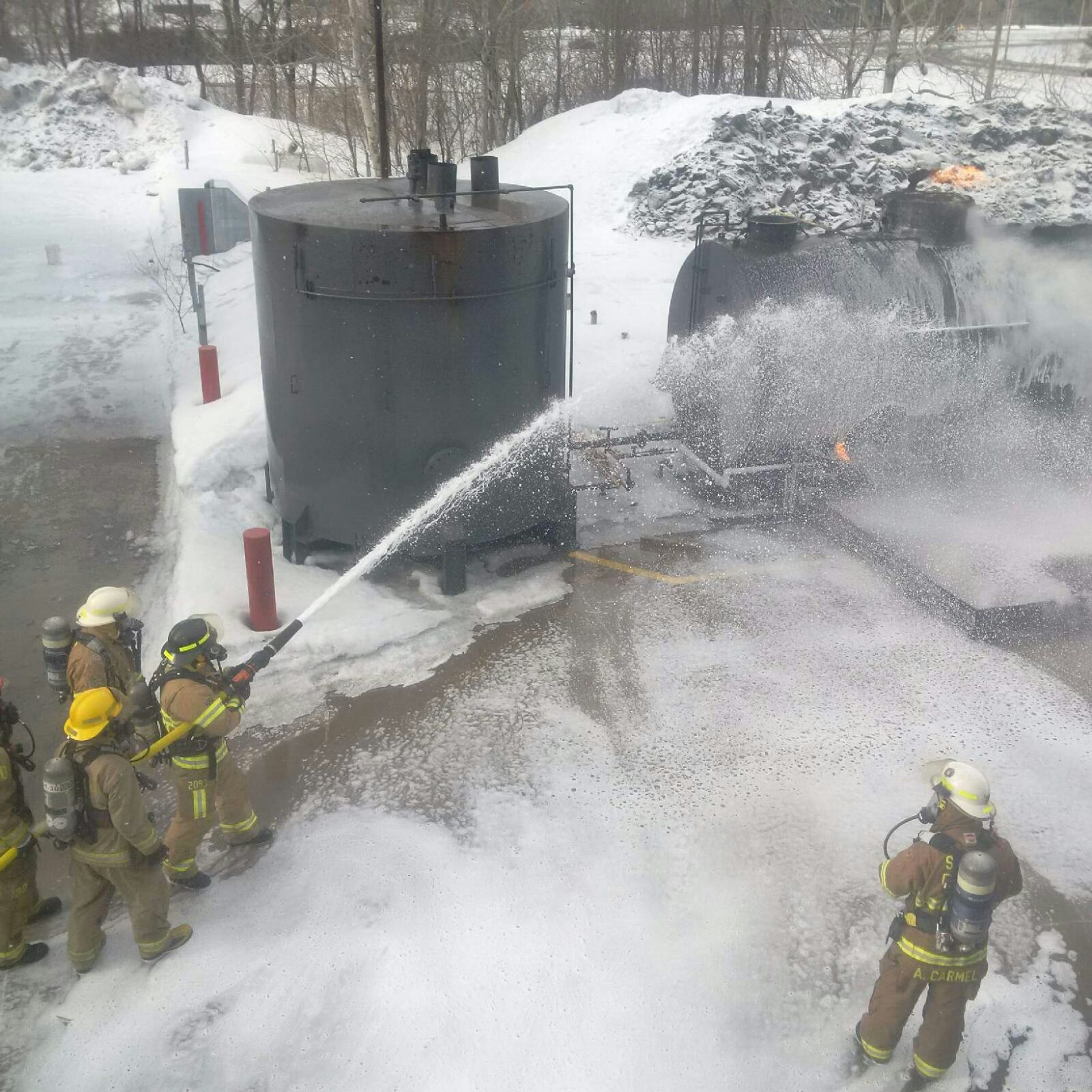 Firefighters use foam to extinguish crude oil fire.