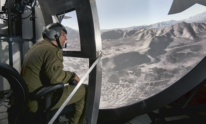 A Load Master trains in a virtual simulator to detect threats to aircraft.