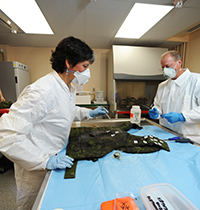 A post incident analysis of used personal protective equipment is conducted by Defence Scientists.