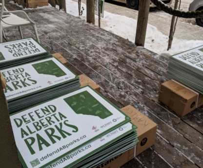 Piles of Defend Alberta Parks lawn sign for distribution.