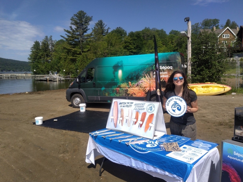 Kayla at the Ocean Wise kiosk during the Plage Saint Joseph beach clean in Quebec.