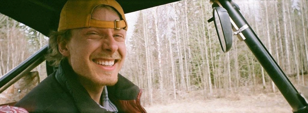 Ben driving through a forest.