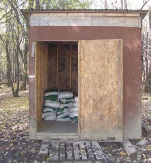 A shed used to store corn kernels at the hunting site; sacks are visible inside