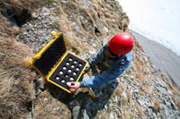 Scientist collecting northern fulmar eggs from High Arctic colony and preparing them for shipment south