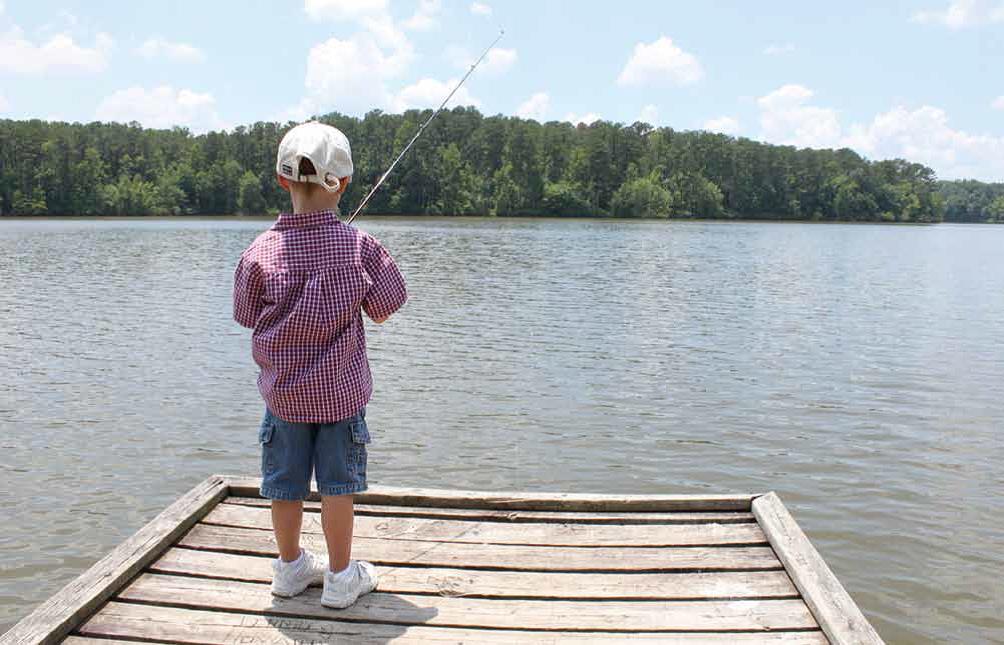 A boy fishes along Lake Ontario.