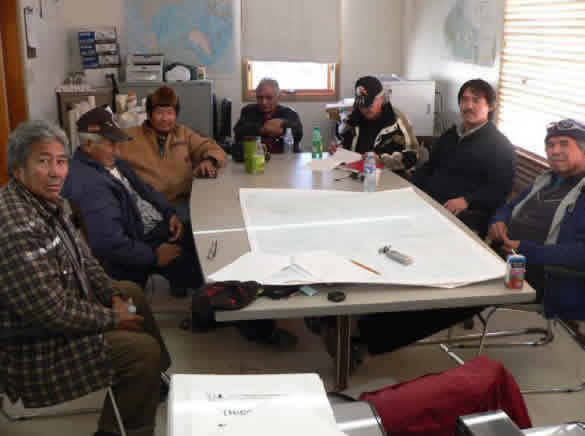 Photograph Fort Providence elders and harvesters meeting regarding boreal caribou. (See long description below)