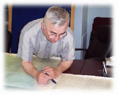Photograph of an elder looking over a map.