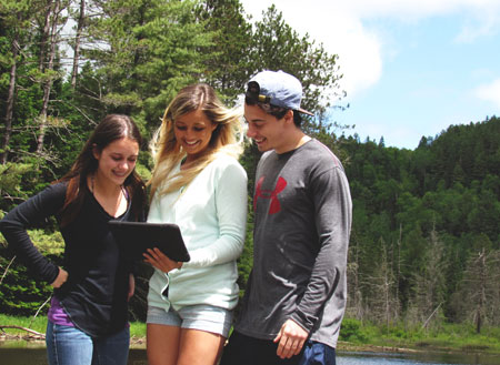 Young visitors using the Nature BioKit at Mauricie National Park