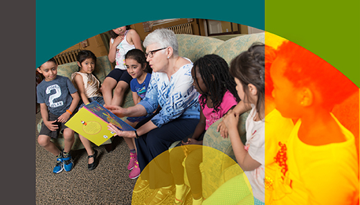 An older adult reading to a small group of children seated together indoors.