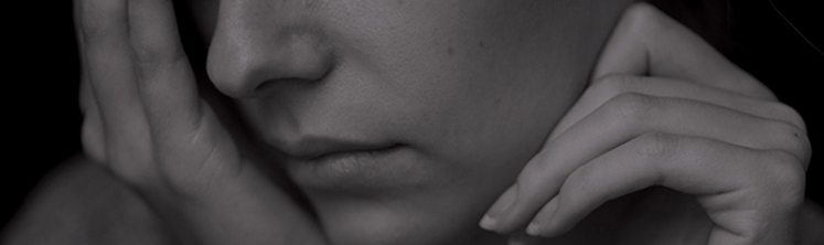 Woman with hands covering her face