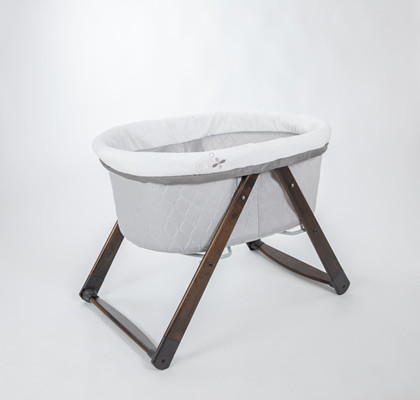A baby bassinet with a wooden base