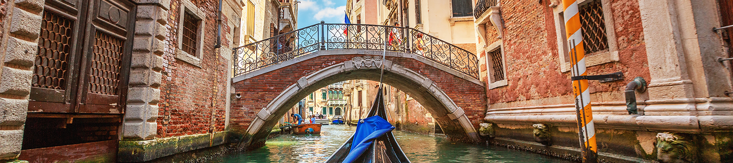 A gondola approaching a bridge in Venice