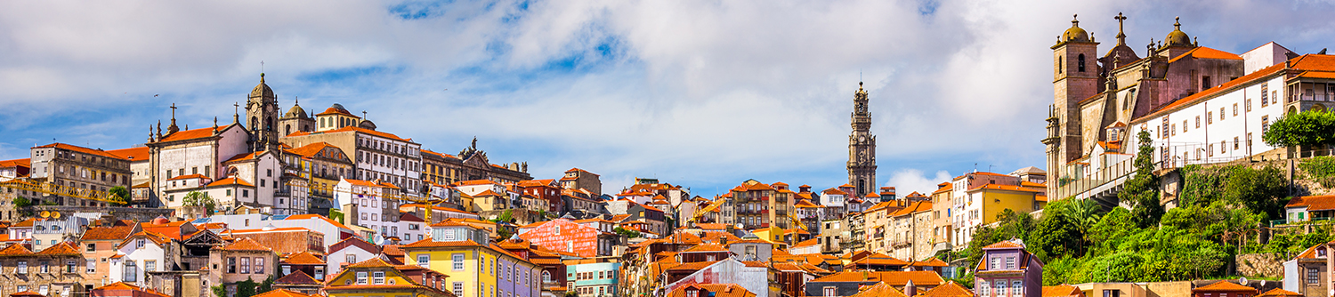 Blue sky and clouds behind a colourful Portugal city