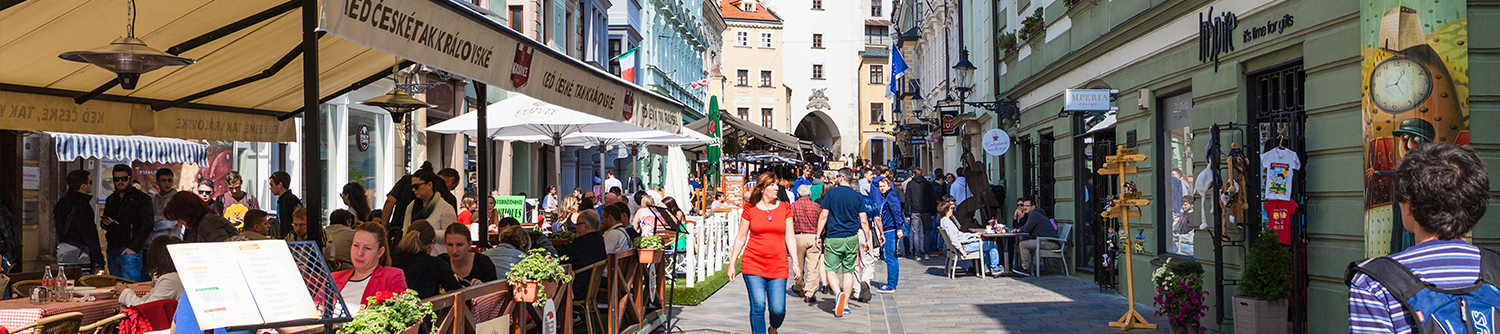 People walk down a busy city street in Slovakia