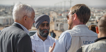 The Honourable Harjit Singh Sajjan and the Honourable John McCallum talked with a member of UNICEF working in a Syrian refugee camp.