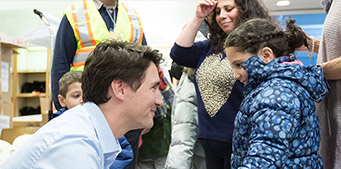 Prime Minister Justin Trudeau welcomes Syrian refugees to Canada late Thursday night at Pearson International airport.