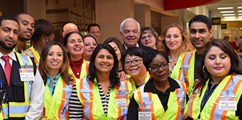 Immigration, Refugees and Citizenship Canada staff take a break to pose for a photo with Minister John McCallum in Toronto.