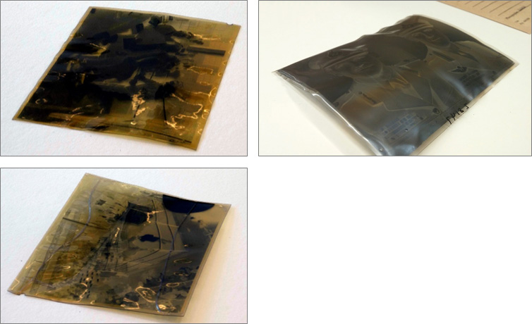 three slightly curled and yellowed   negatives
