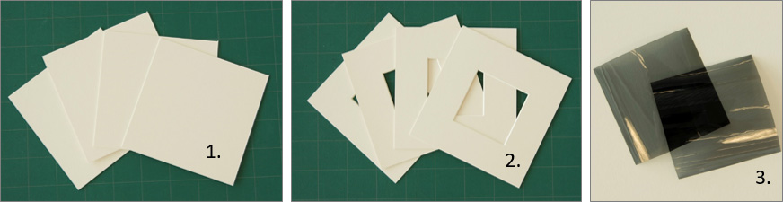 four mat boards with cutted-out centers and two polarizing films as described in steps 1 to 3