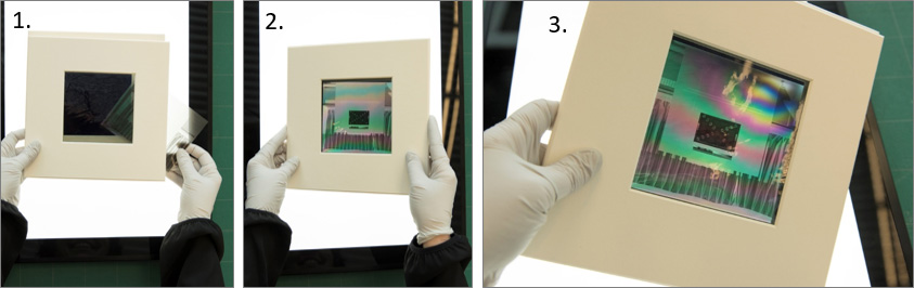 gloved hands manipulating a polarizing viewer with a negative inside as described in steps 1 to 3