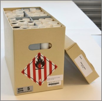 box containing paper rolls of rolled nitrate separated in four sections