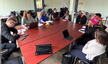 people sitting around a conference room table