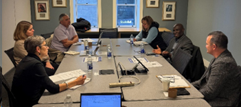 people sitting around a conference room table