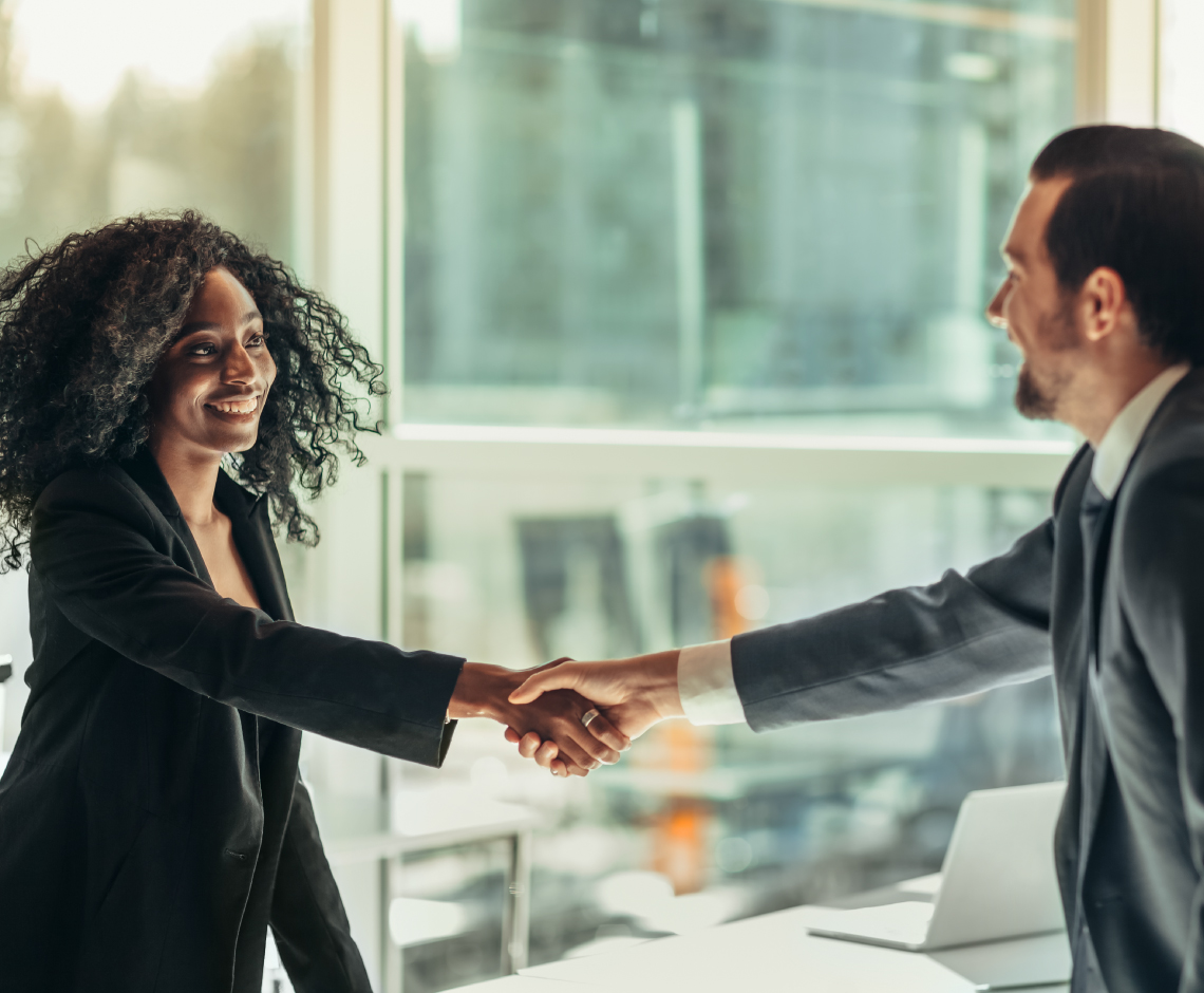 Two working people shaking hands.
