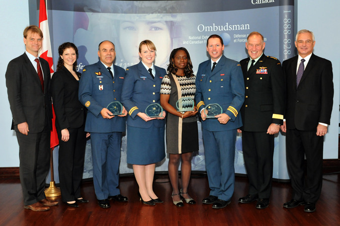 Commendations recipients pose with their awards. Text equivalent to follow. 