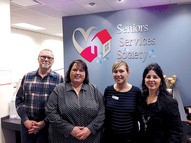 Image of the Taxpayers’ Ombudsman with three members of the executive team at the Seniors Services Society in Vancouver, British Columbia.